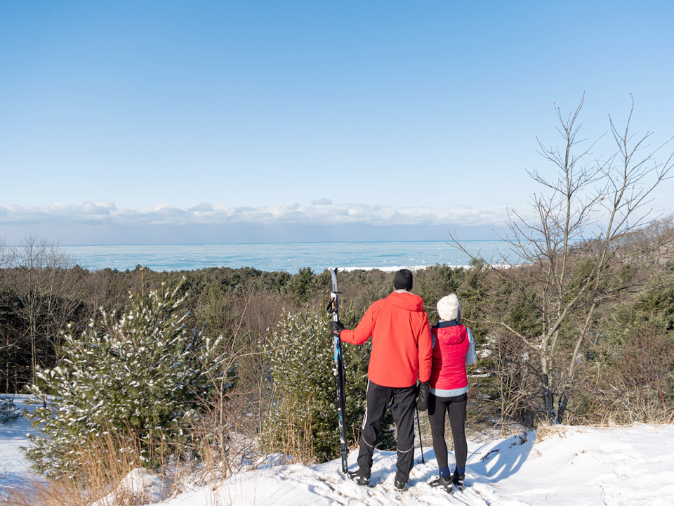 Couple looking over the Dunes after a day cross country skiing